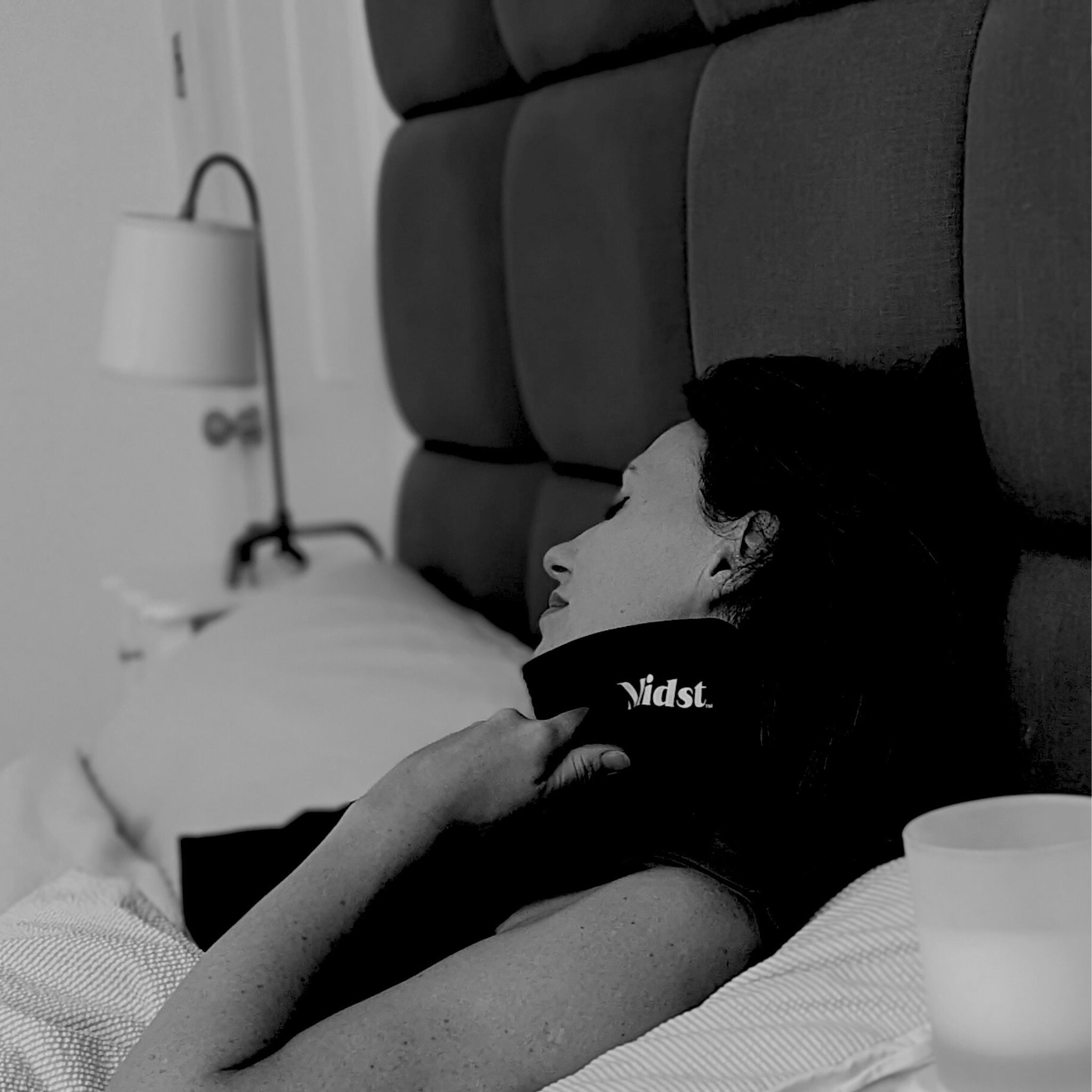 Lady using Midst Hot Flush Cooling Pillow to ease a hot flush, wrapped around neck