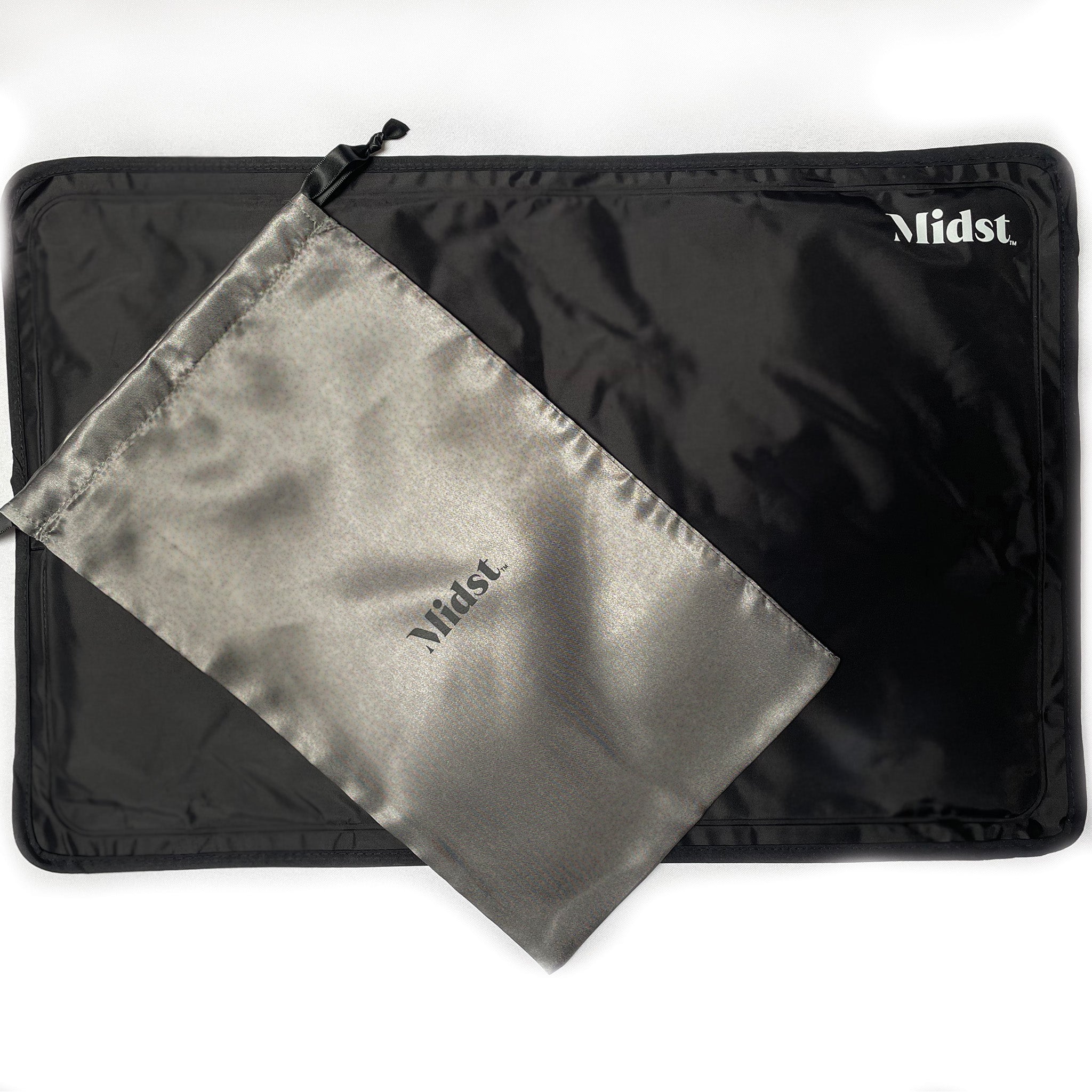 Midst Hot Flush Cooling Gel Pillow. Black flat PVC Pillow lying flat, with grey satin ouch sitting on top.